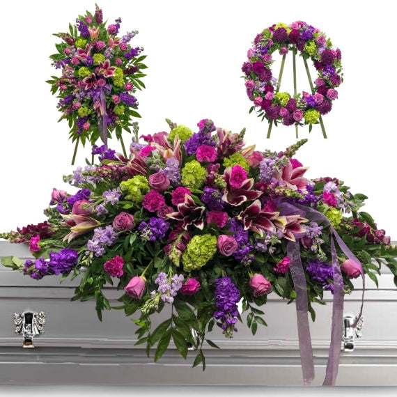 Shades of lavender and purple flowers in a funeral spray  Church flower  arrangements, Funeral flower arrangements, Funeral flowers